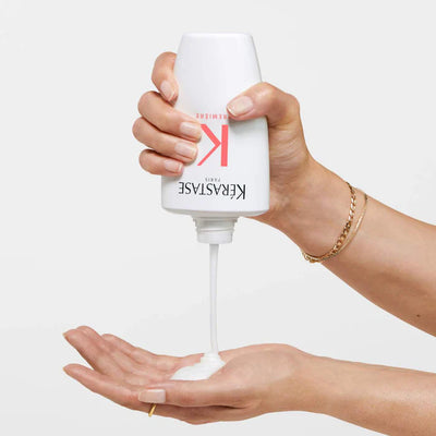 Decalcifying shampoo being poured into a hand, promoting smooth and manageable hair for damage repair.