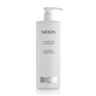 Nioxin Clarifying Cleanser in a pump bottle, designed to remove chlorine and mineral deposits from all hair types.