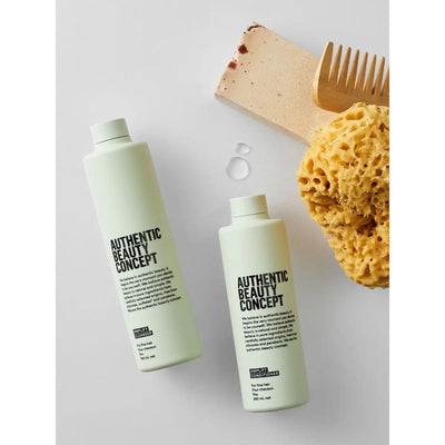 Authentic Beauty Concept Amplify Cleanser and Conditioner with a wooden comb and natural sponge, free from silicones and parabens.