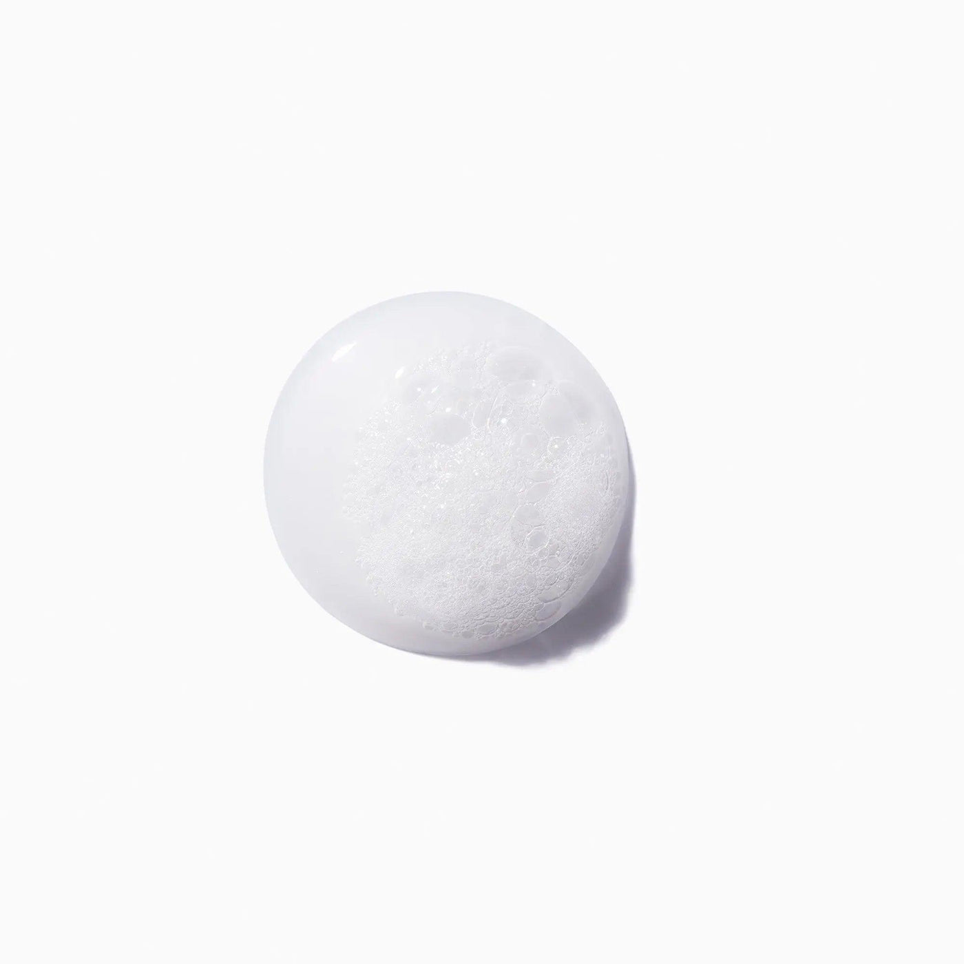 Foamy face cleanser bubble on white background.