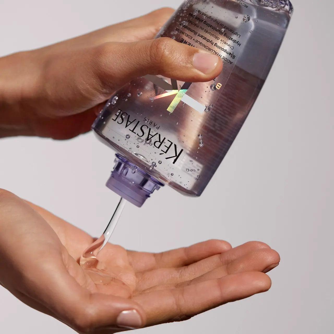 Pouring Kerastase hair product into hand for care routine