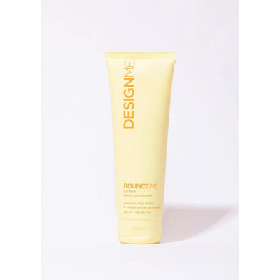 DESIGNME Bounce Me Curl Balm 8.5 oz in a yellow tube for curly hair care.