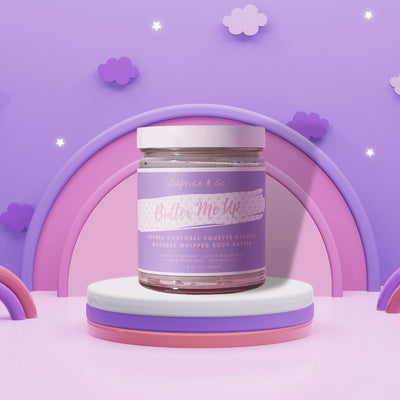 Butter Me Up bubblegum-scented whipped body butter in a jar against a whimsical pastel background.