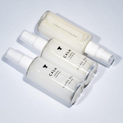 3 skincare spray bottles labeled Calm on light background; calm skin spray for soothing and hydrating face.