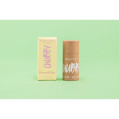 Compostable vegan lip balm with eco-friendly packaging on a green background, perfect for hydration and lip care.