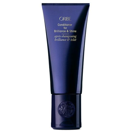 Oribe Conditioner for Brilliance & Shine in blue bottle with gold lettering, designed to enhance hair shine and smoothness.