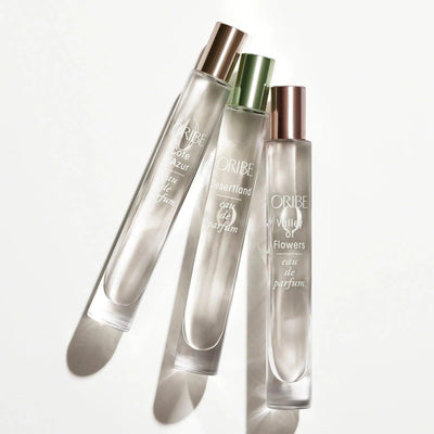 Three Oribe Eau de Parfum bottles including Côte d’Azur, Les Sables d’Or, and Village of Flowers.