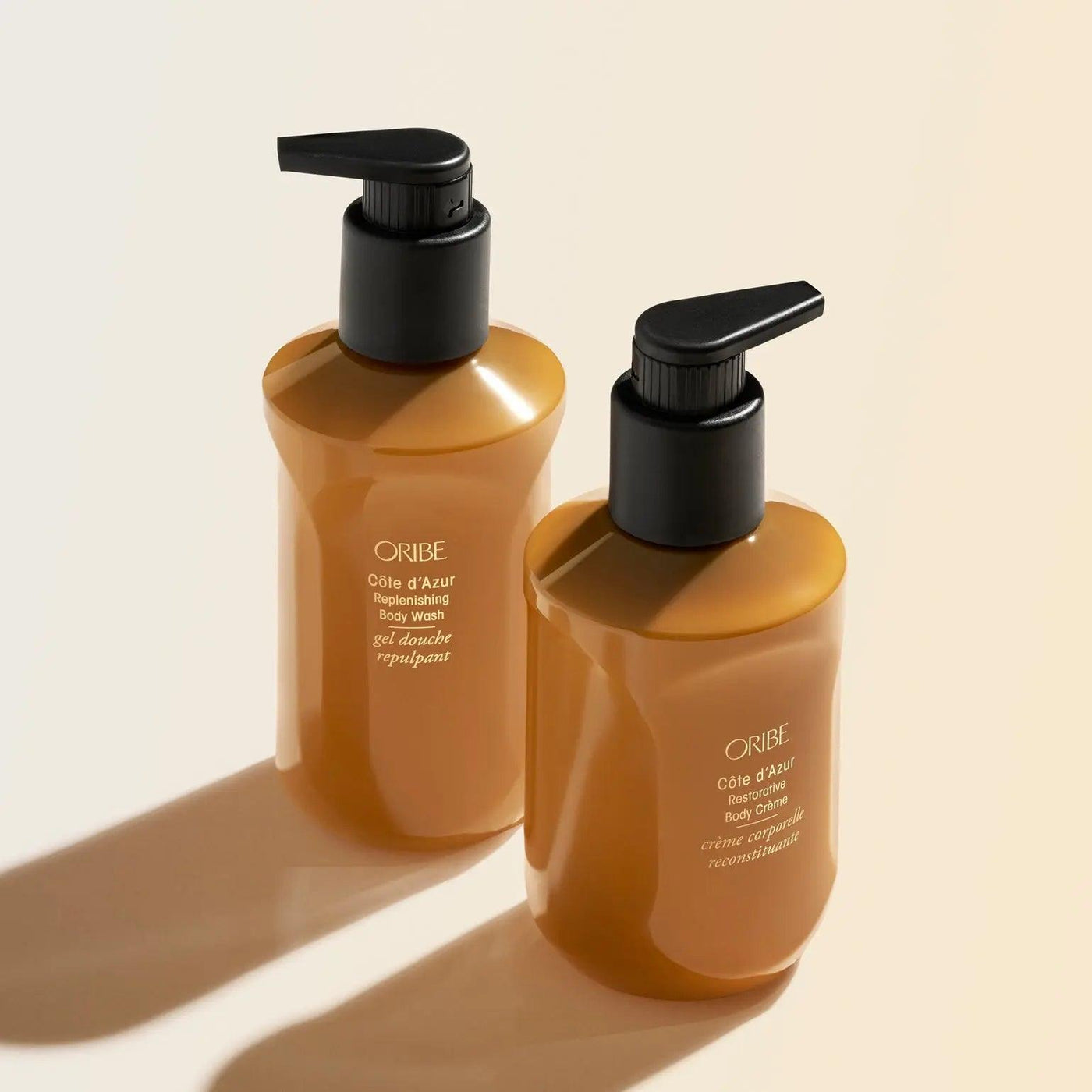 Oribe Côte d'Azur Replenishing Body Wash bottles showcasing luxurious design and signature fragrance for silky soft skin.
