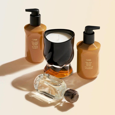 ORIBE Côte d’Azur body care products, including body wash, hand soap, and signature candle in elegant packaging.