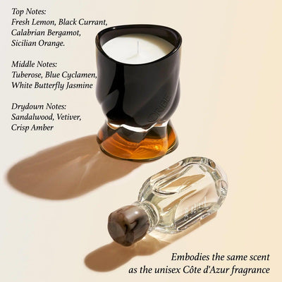 Cote d'Azur scented candle by ORIBE with fragrance notes of lemon, bergamot, jasmine, and sandalwood displayed beside the unisex fragrance bottle.