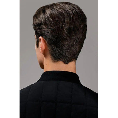 Back view of man with stylish short dark hair, wearing a black quilted jacket.