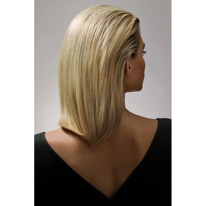 Blonde woman with sleek short haircut viewed from the back wearing a black top