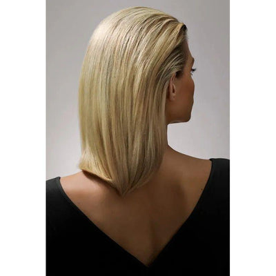 Blonde woman with sleek short haircut viewed from the back wearing a black top