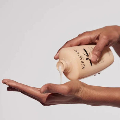 Kerastase Curl Manifesto Bain Hydration Douceur shampoo being poured into a hand, ideal for curly and coily hair care.