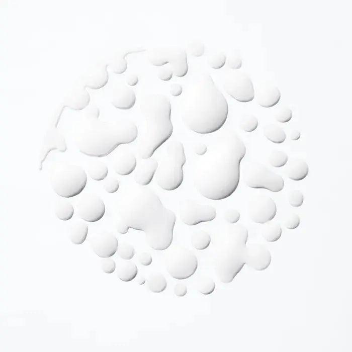 White droplets on a light background, creating a textured circular pattern.