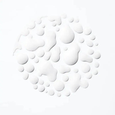White droplets on a light background, creating a textured circular pattern.
