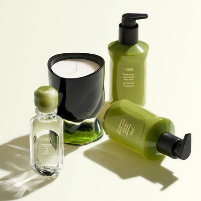 Oribe Desertland body wash, shampoo, and candle showcasing luxury skincare and fragrance in elegant green packaging.