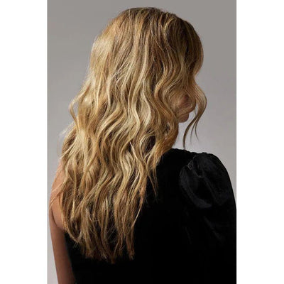 Long wavy blonde hair on woman with black top, stylish hairstyle, back view