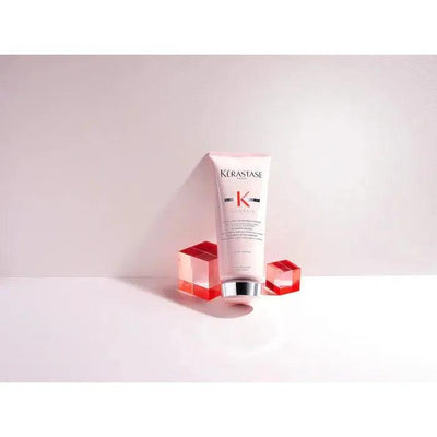 Kerastase hair product for smooth, healthy hair with premium care and shine on a white background with red cubes.