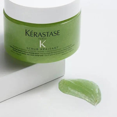Kérastase Scrub Apaisant soothing hair scrub in green jar with product smear.