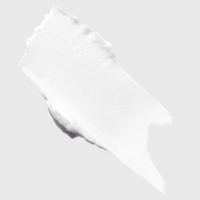 Swatch of Kérastase Genesis Homme Cire d'Épaisseur Texturisante, a smooth white texturizing hair wax for men.