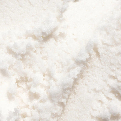 Gilded Woods Body Scrub texture featuring a fluffy, moisture-rich white formulation with pure cane sugar and coconut oil.
