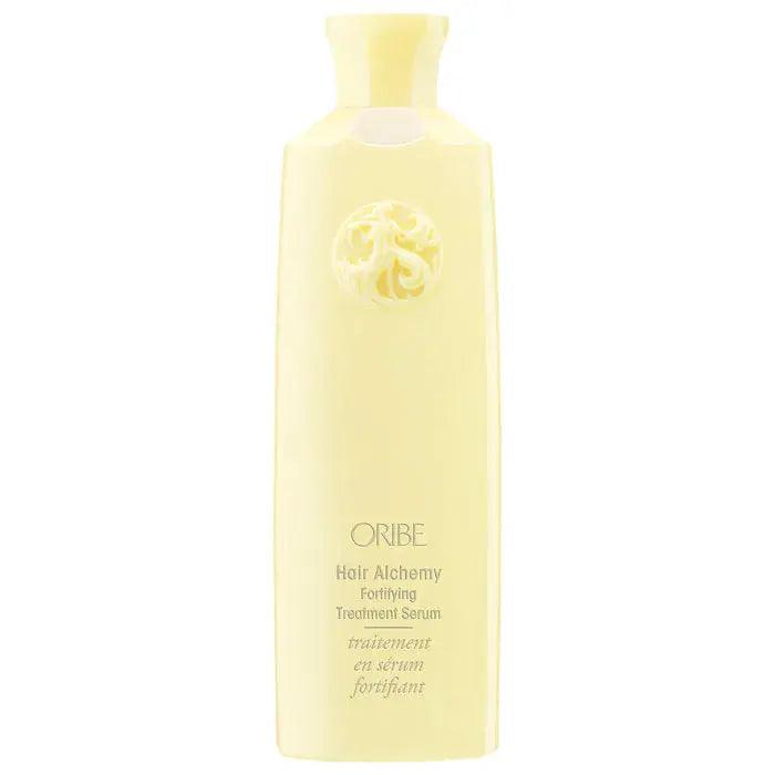 ORIBE Hair Alchemy Fortifying Treatment Serum in a sleek yellow bottle, designed to strengthen and protect hair.