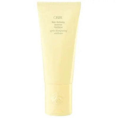 Oribe Hair Alchemy Resilience Conditioner in yellow tube for strength, softness, and moisture for hair care.