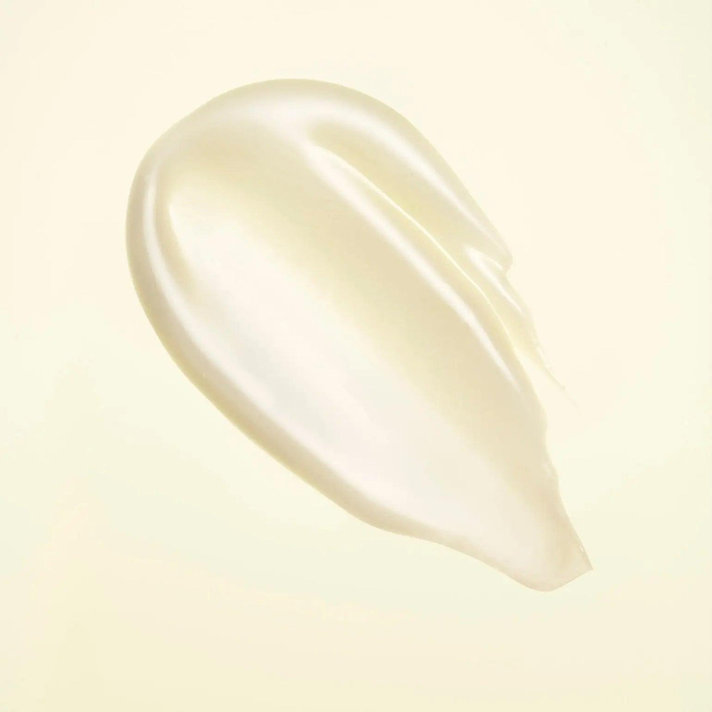 smooth and creamy texture of Hair Alchemy Resilience Conditioner against a soft background