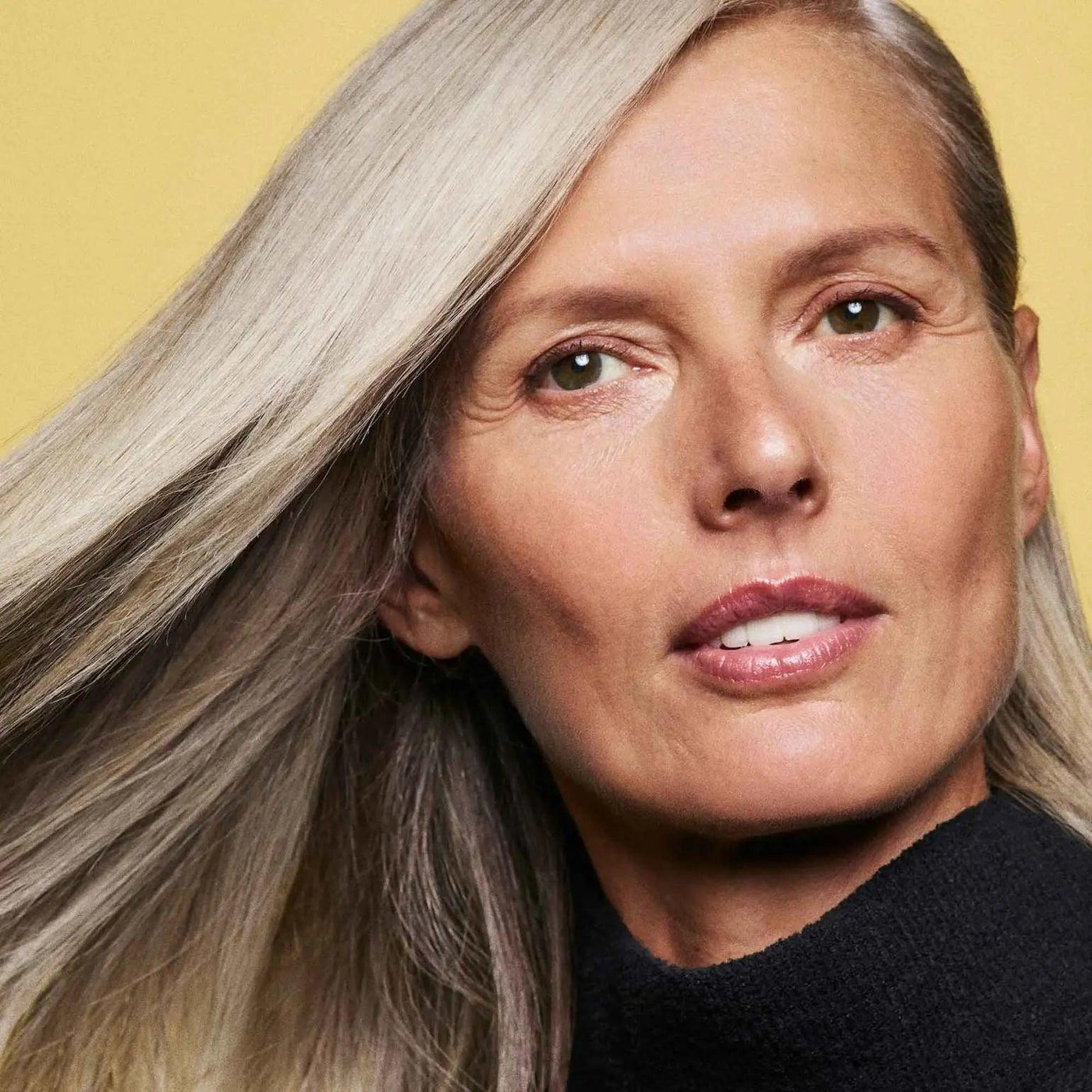 Woman with radiant long hair showcasing healthy shine, representing the benefits of Hair Alchemy Resilience Conditioner.