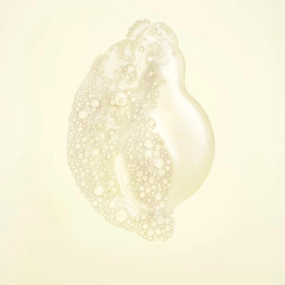 Nourishing shampoo bubble texture showcasing a creamy, foamy cleanser for strengthening hair.