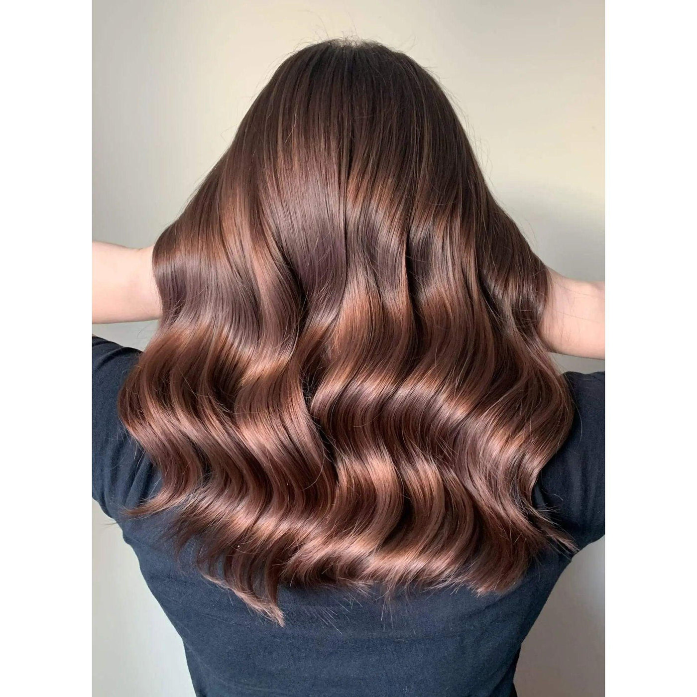 Beautiful wavy hairstyle showcasing shiny, healthy hair using the Iconic Styling Duo for frizz control.
