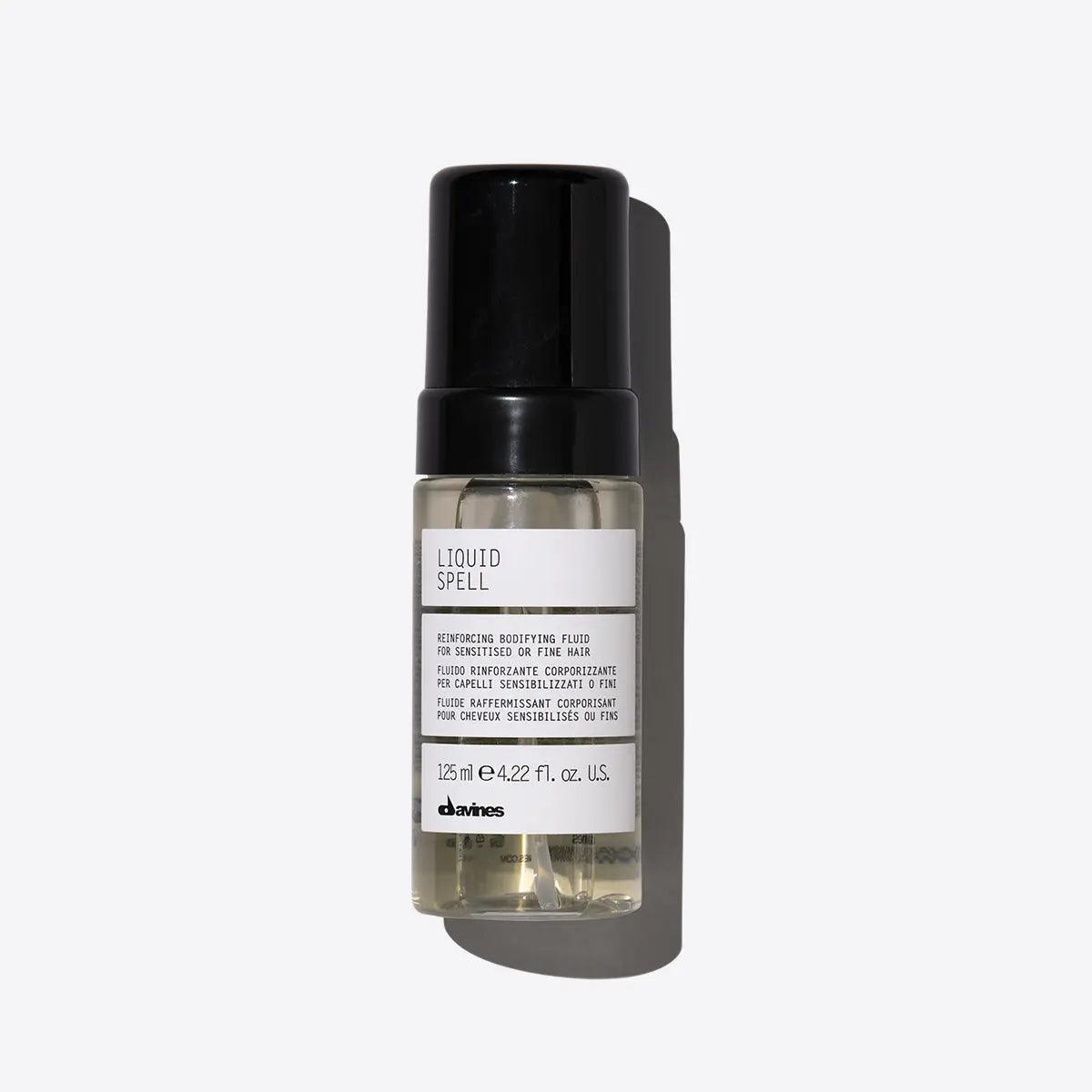 Davines Liquid Spell Bodifying Fluid in a glass bottle, designed to strengthen and volumize fine hair.