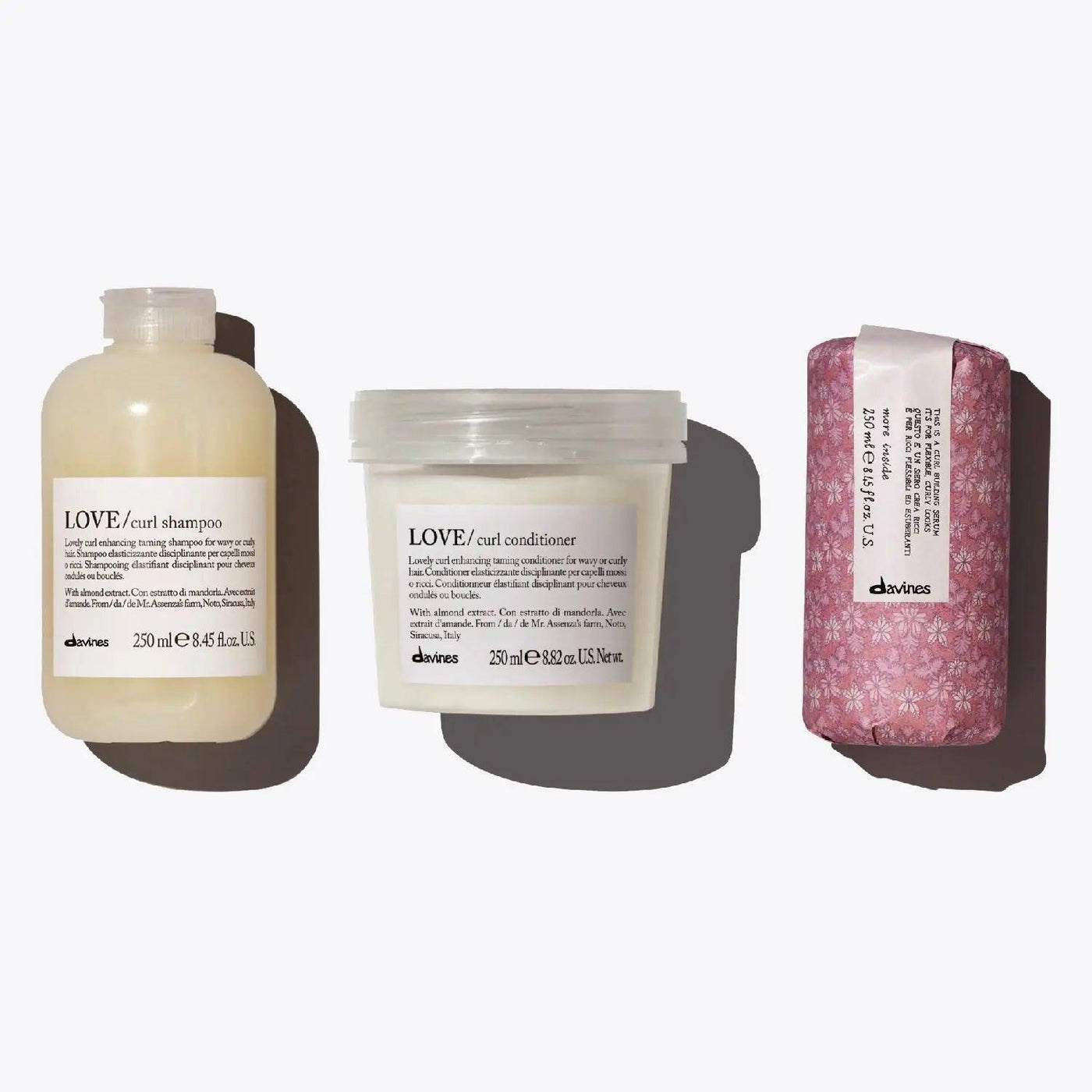Davines Love Curl Set featuring shampoo, conditioner, and curl serum for enhancing curls and controlling frizz.
