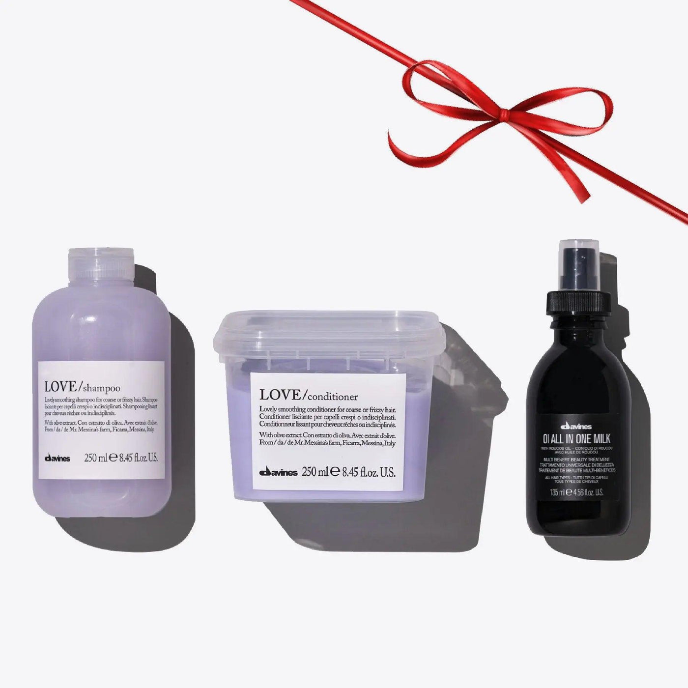 Davines Love Smoothing + Oi Set with shampoo, conditioner, and Oi All In One Milk for nourished, shiny hair.