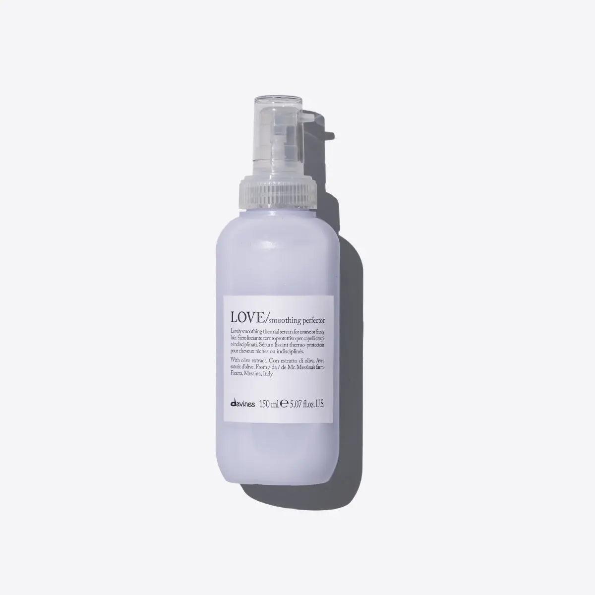 Love Smoothing Perfector thermal serum for frizzy hair in sleek spray bottle, offering thermal protection and easy styling.