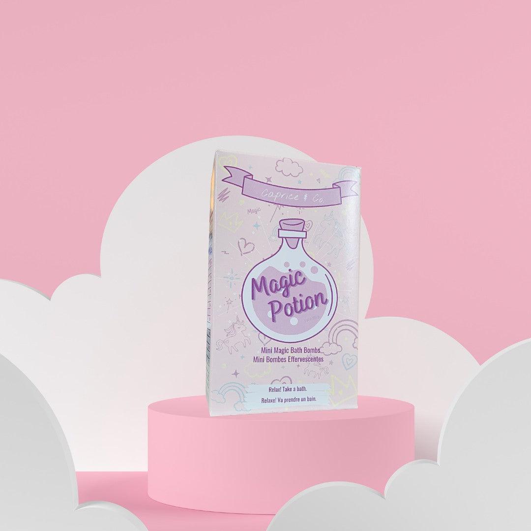 Magic Potion Mini Bath Bombs packaging on pink background with clouds, featuring jellybean scent and natural ingredients.