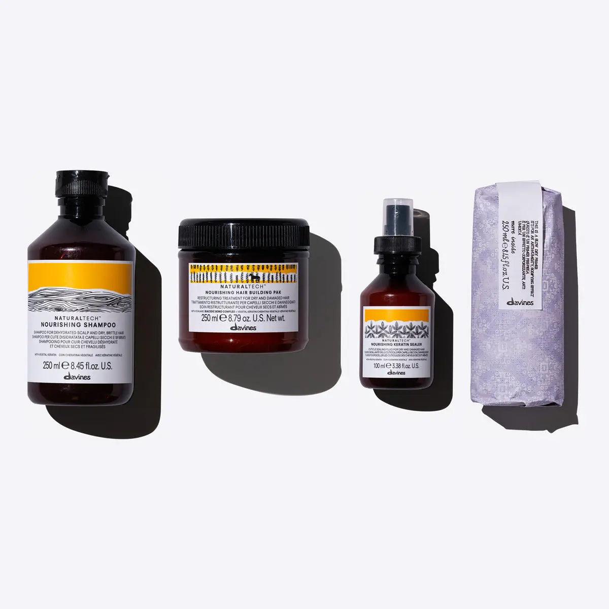 Nourished Blowout Set by Davines featuring shampoo, conditioner, oil, and treatment for healthy hair.