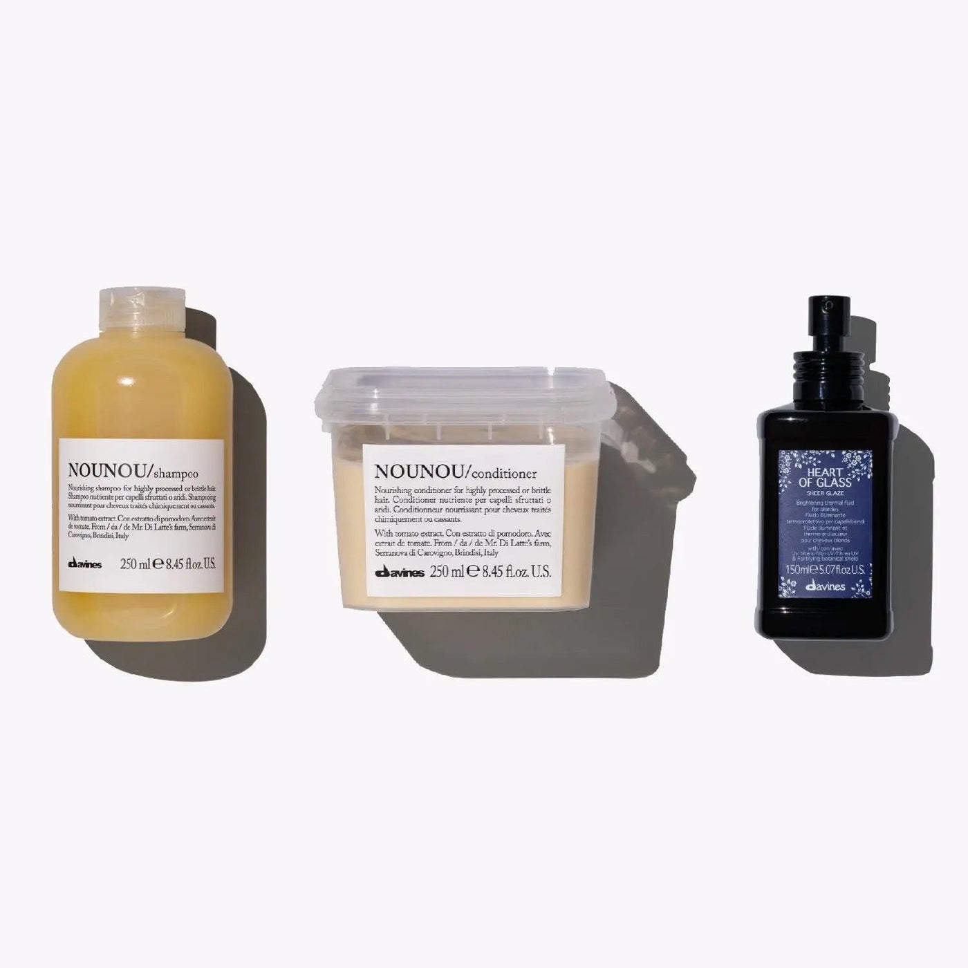 Nourishing set for blonde hair featuring NOUNOU shampoo, conditioner, and Heart of Glass heat protectant.