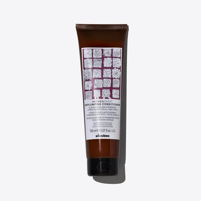 Replumping Conditioner tube by Davines, packed with moisturizing ingredients for elastic and untangled hair.