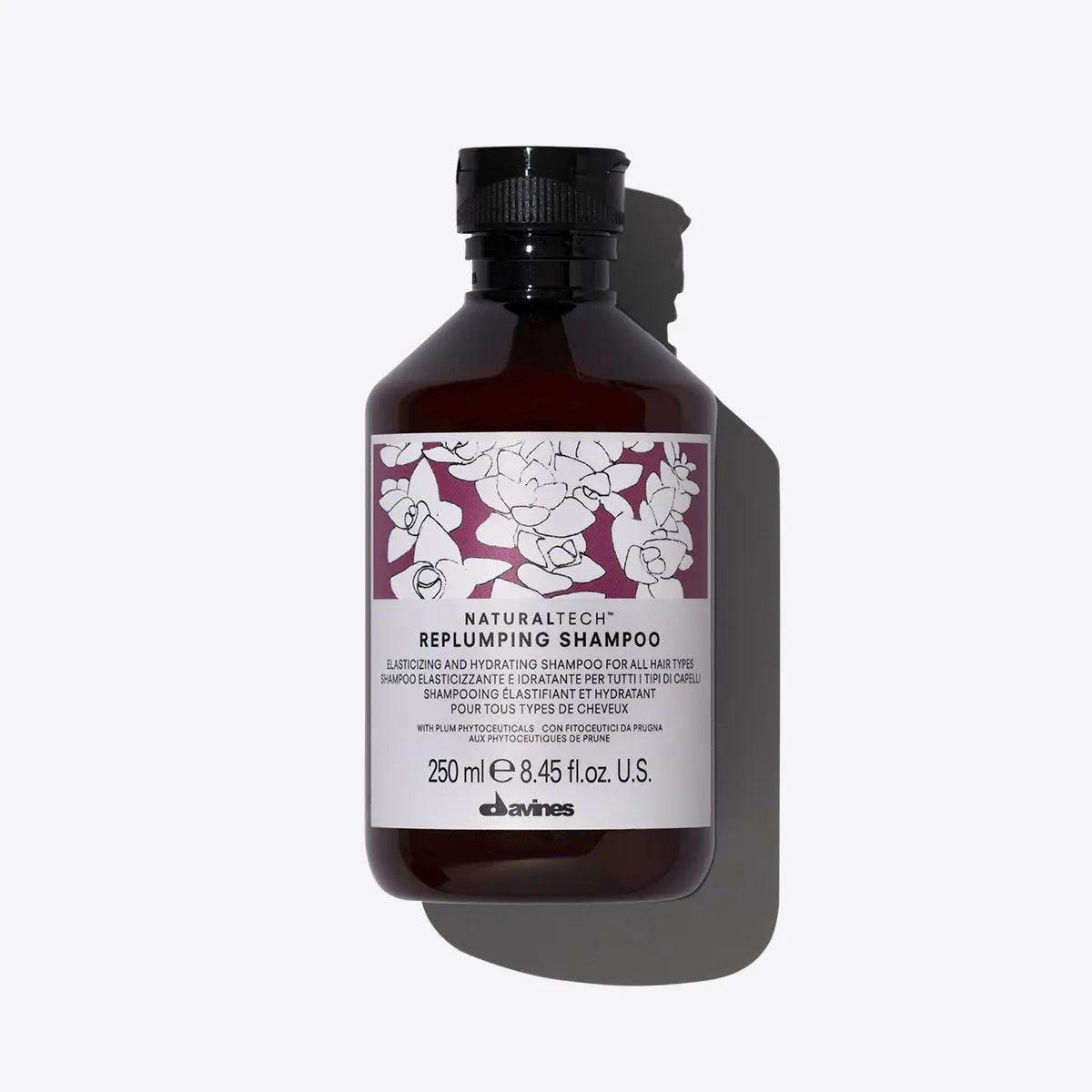 Replumping Shampoo bottle with creamy texture, 250 ml, enhances elasticity and hydration for healthy hair.