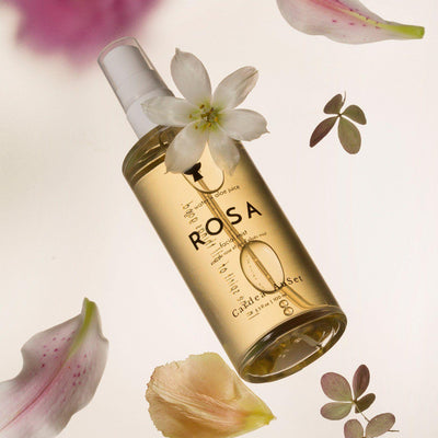Rosa candle and body oil set with floral elements, luxury spa product with calming fragrance, perfect for relaxation and self-care.