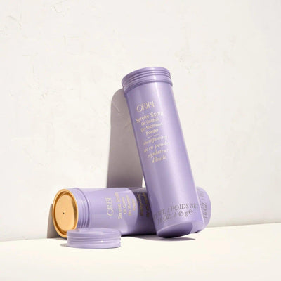 Serene Scalp Oil Control Dry Shampoo Powder by Oribe in purple packaging on a light background.