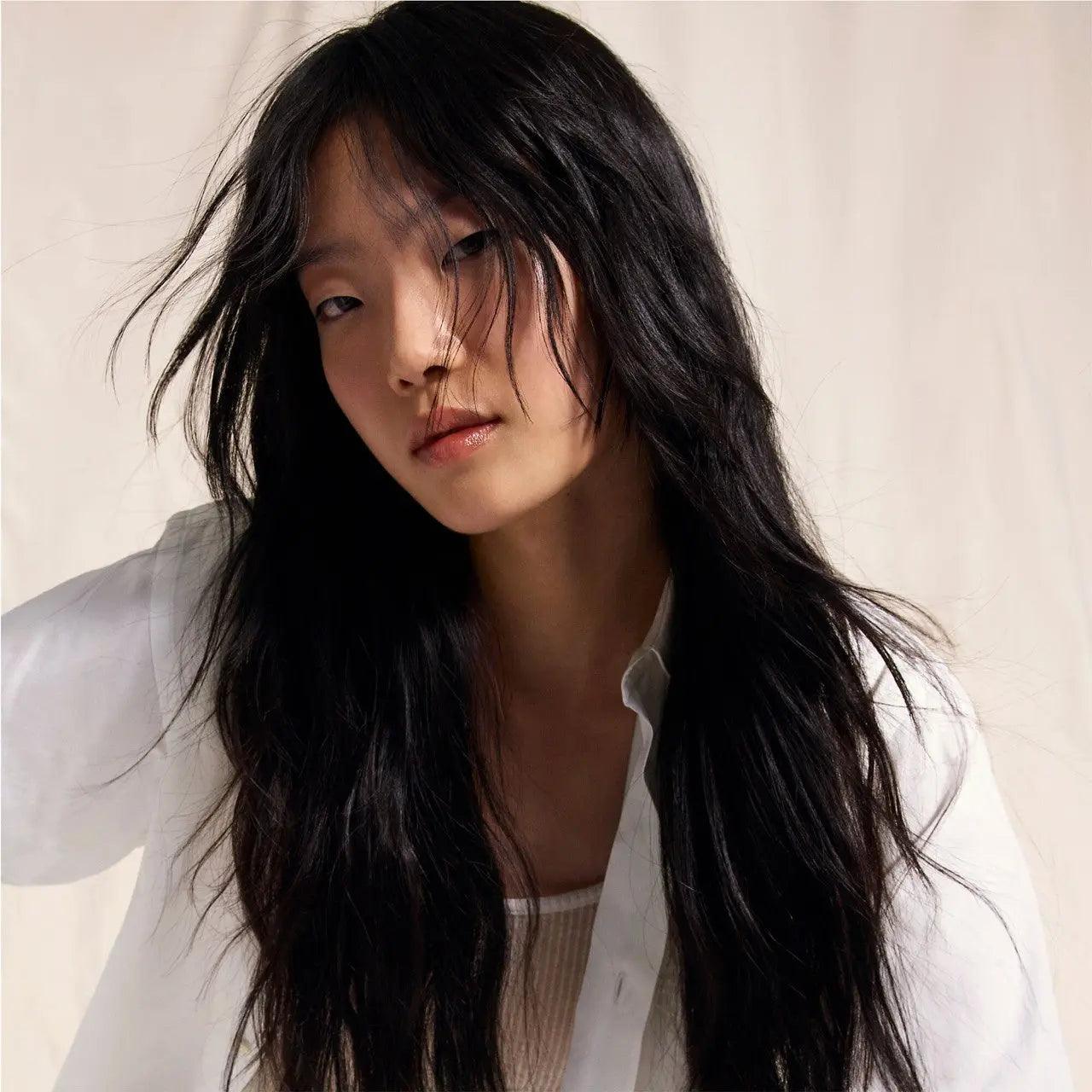 Model showcasing sleek, healthy hair texture, emphasizing the benefits of scalp oil control treatment.