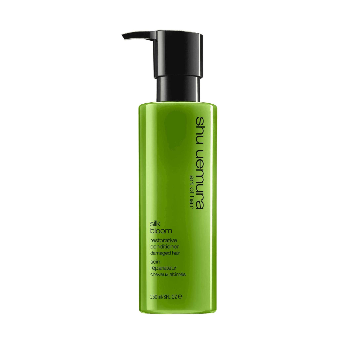 Shu Uemura Silk Bloom Conditioner in green bottle, nourishing product for damaged, dry, and chemically-treated hair.