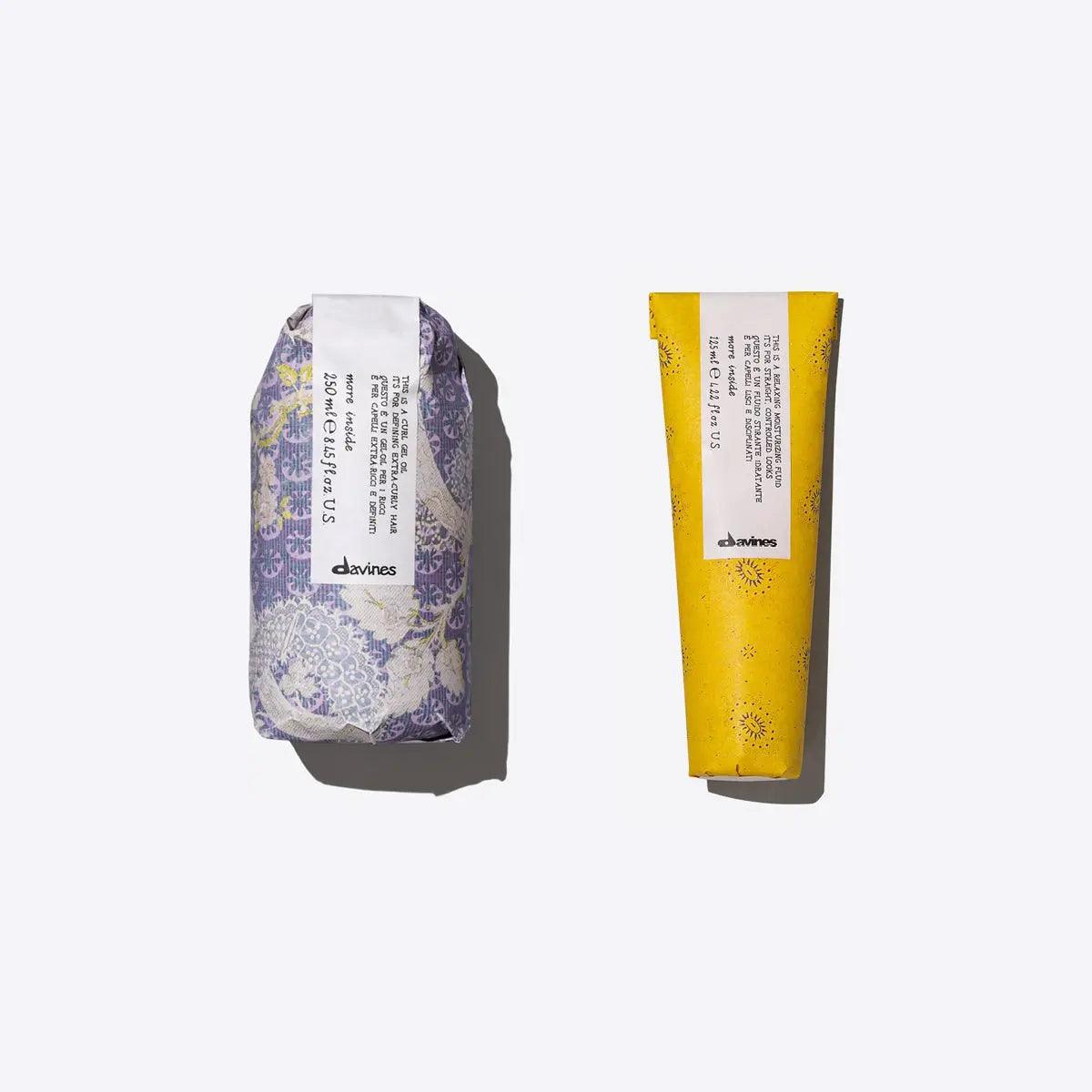 Two Davines hair products for curls, featuring a moisturizing fluid and curl gel oil in colorful packaging.