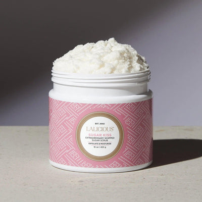 Sugar Kiss Sugar Scrub in a white jar with pink patterned label, promoting exfoliation and hydration for radiant skin.