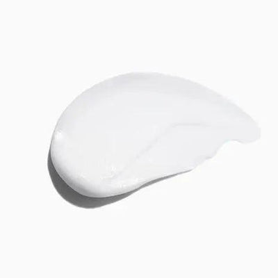 Smooth, creamy texture of Symbiose Fondant Apaisant Essentiel hair conditioner on a white background.