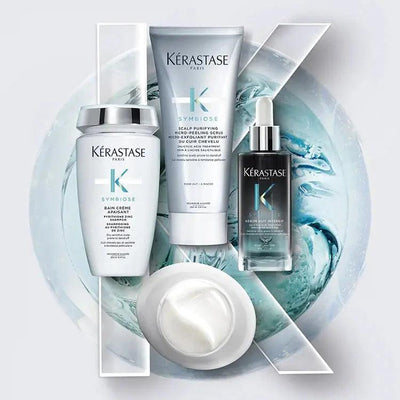 Kérastase Symbiose hair care products including serum, conditioner, and mask on a stylish blue background.