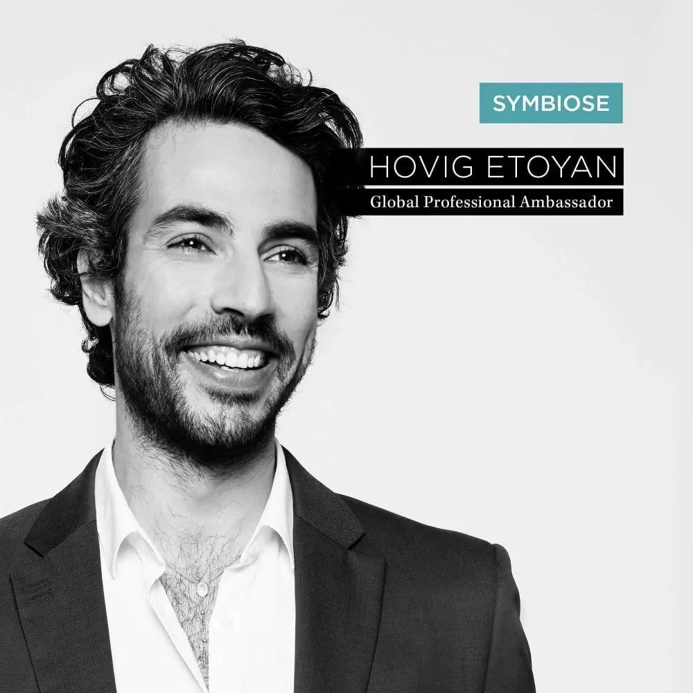 Hovig Etoyan, Global Professional Ambassador for Symbiose, smiling in a professional suit with dark hair.